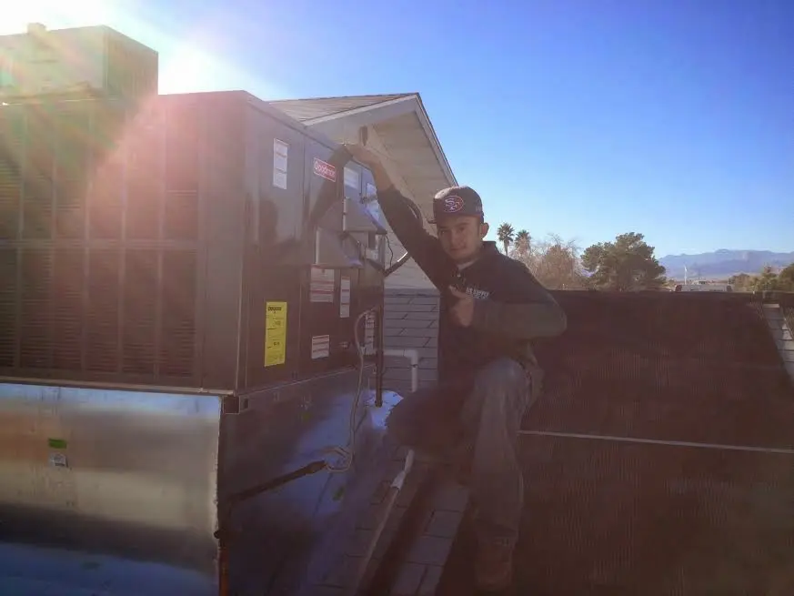 HVAC technician performing Boiler Repair on a rooftop unit in Fruitland